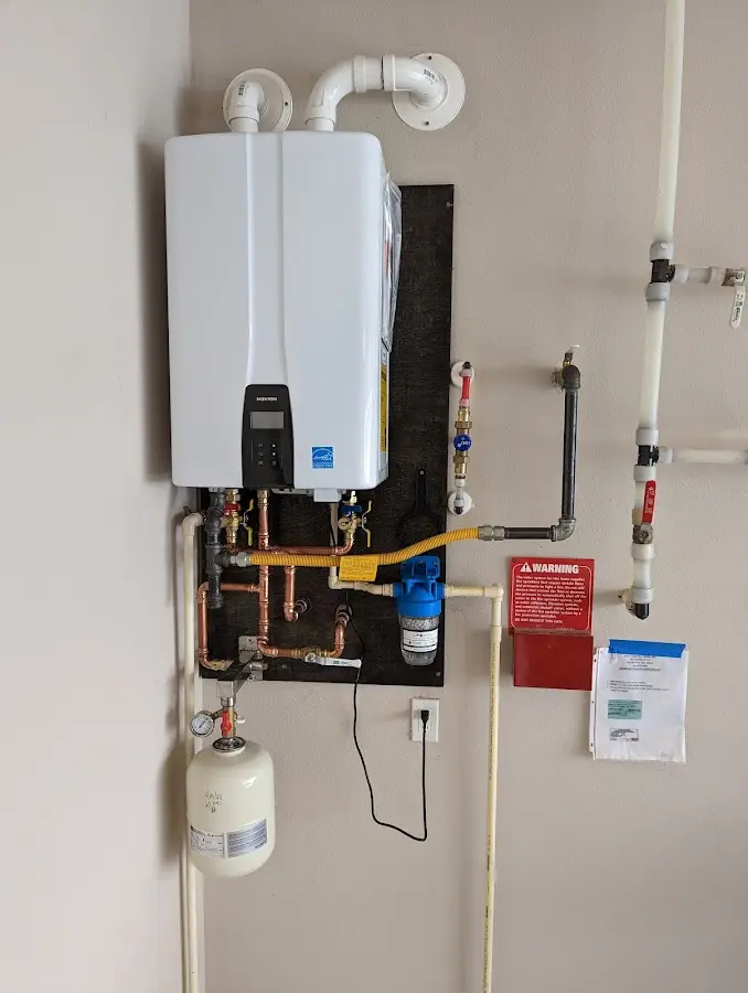 Professional plumber installing copper piping in a Montgomery home
